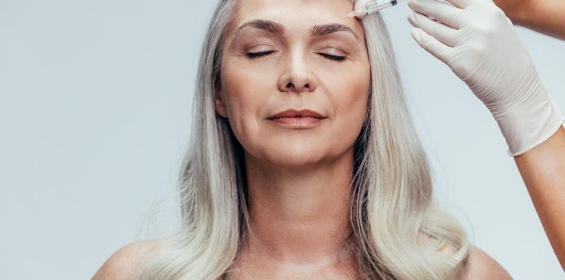Older woman using cosmetic injections for anti-aging