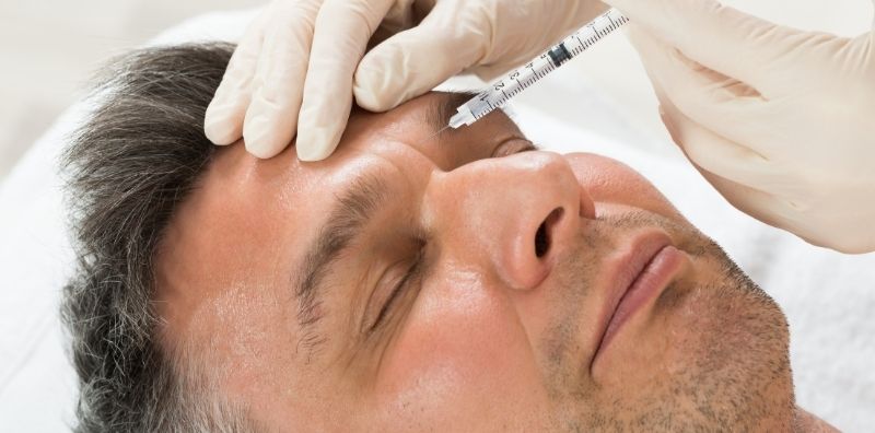 Middle aged man getting Botox injections