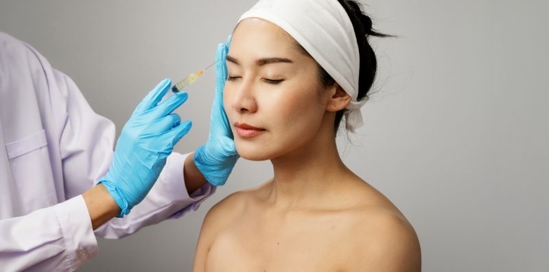 Asian woman getting botox injections