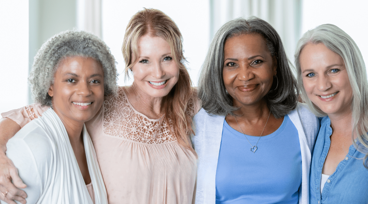 Four women of various ages embracing 