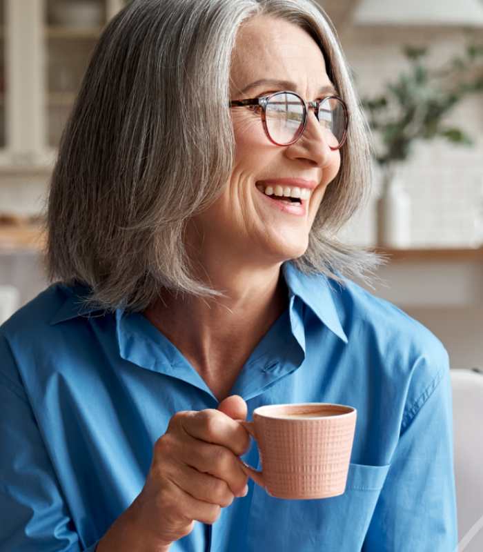 Female hormone replacement client drinking a cup of coffee